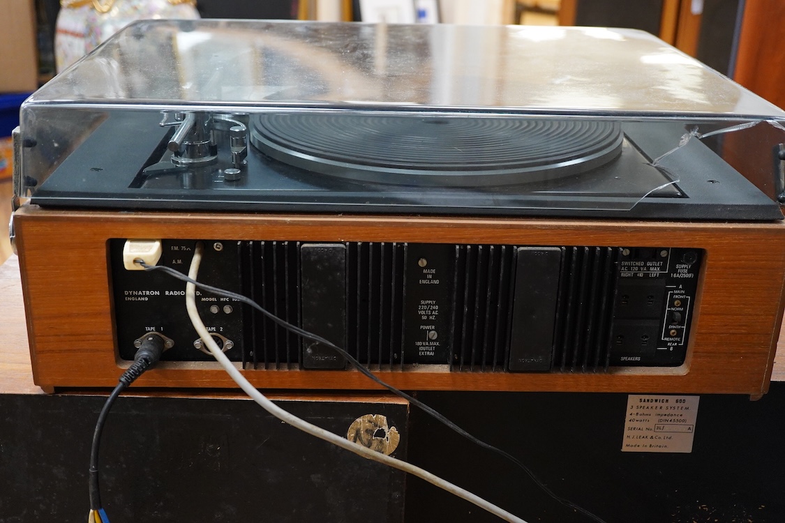 A Dynatron Goldring GL78 turntable with integral amplifier and tuner, made in Switzerland, together with a pair of Leak Sandwich 600 stereo speakers in teak cabinets, 65cm high